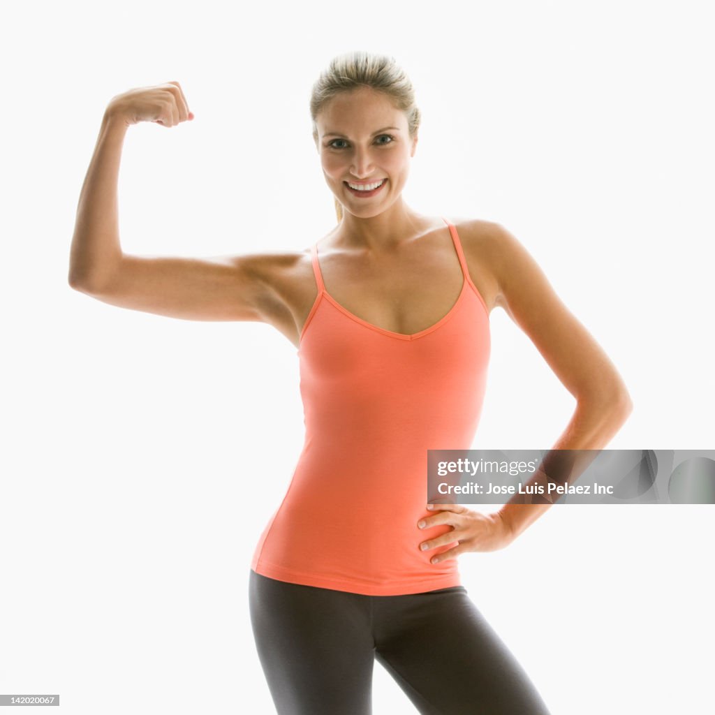 Caucasian woman flexing her muscles