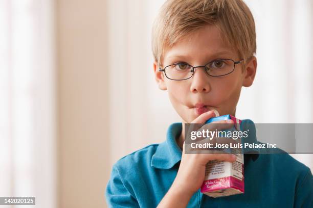 caucasian boy drinking juice box - holding cold drink stock pictures, royalty-free photos & images