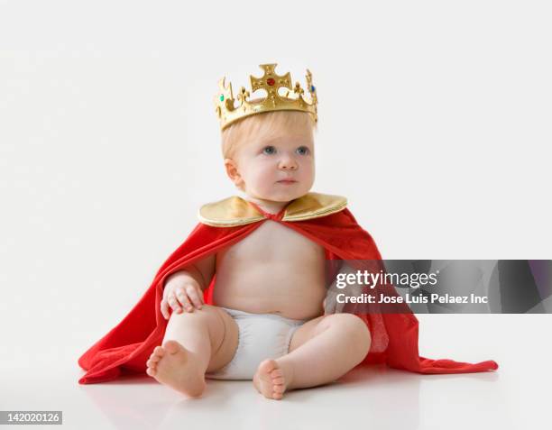 caucasian baby boy dressed as king - royal baby stock-fotos und bilder