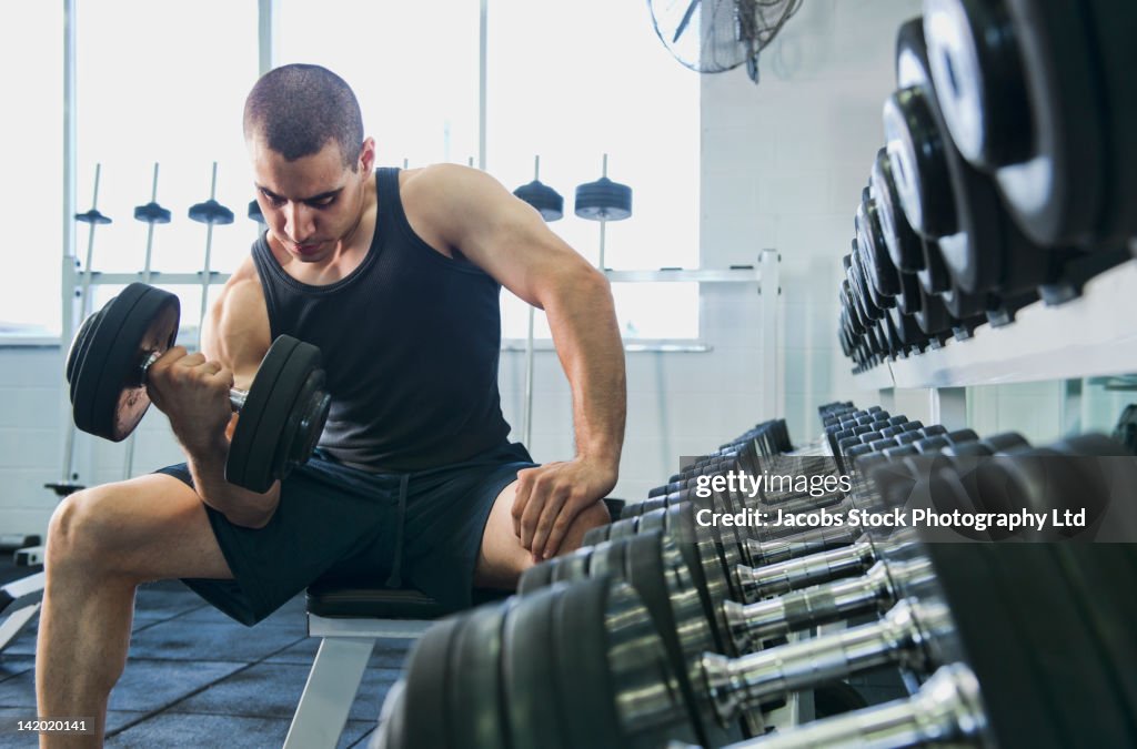 Middle Eastern man exercising with dumbbells