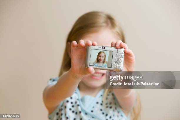 girl holding digital camera with self-portrait - digitalkamera bildschirm stock-fotos und bilder