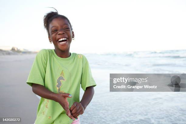 laughing jamaican girl on beach - african girls on beach stockfoto's en -beelden