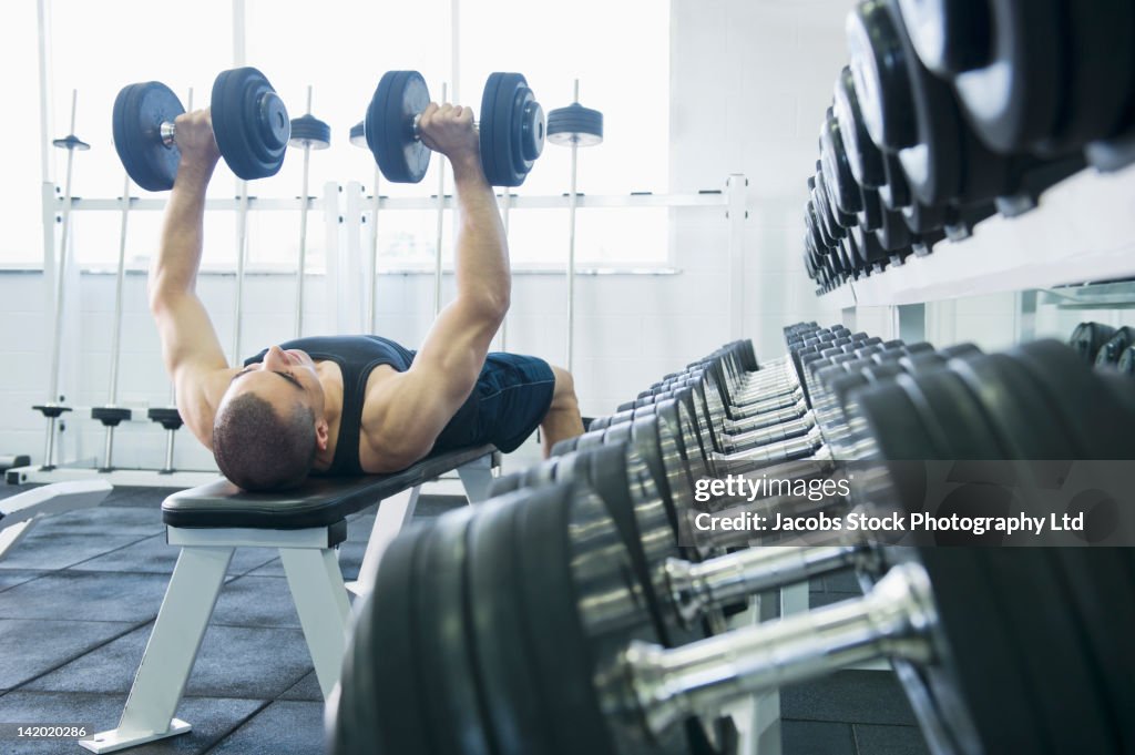 Middle Eastern man exercising with dumbbells