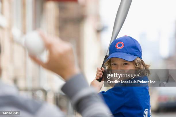 caucasian boy playing baseball with father - child batting stock pictures, royalty-free photos & images