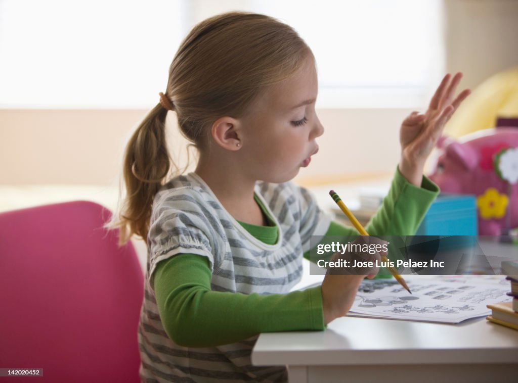 Caucasian girl doing math homework