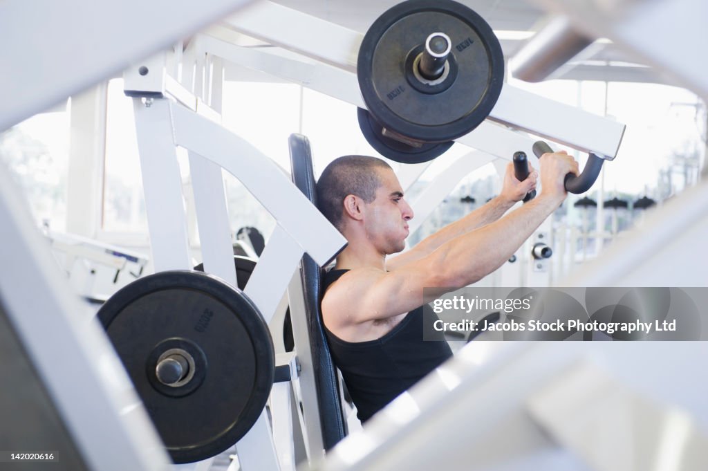Middle Eastern man exercising in health club