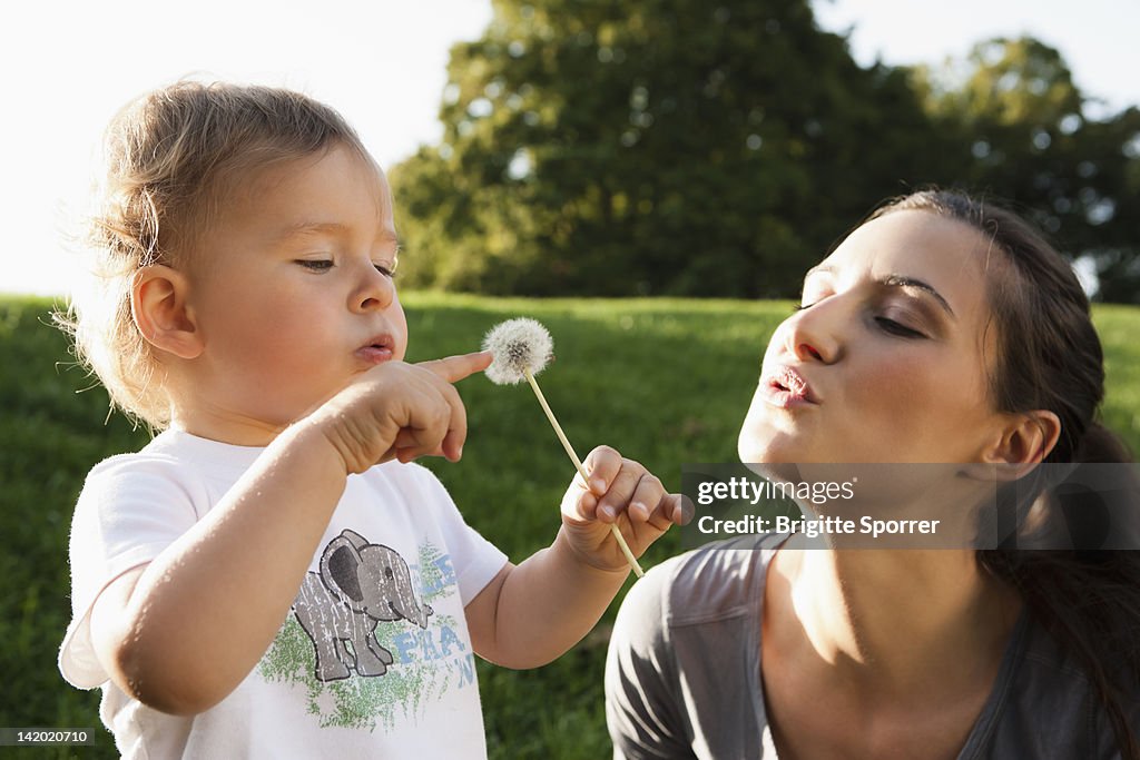 Mother and toddler playing in park