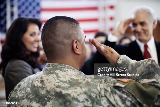soldier saluting politician at political gathering - navy marine and army commandos stock-fotos und bilder