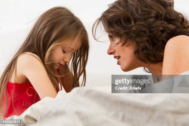 mother and daughter talking on bed - mom scolding child stock pictures, royalty-free photos & images