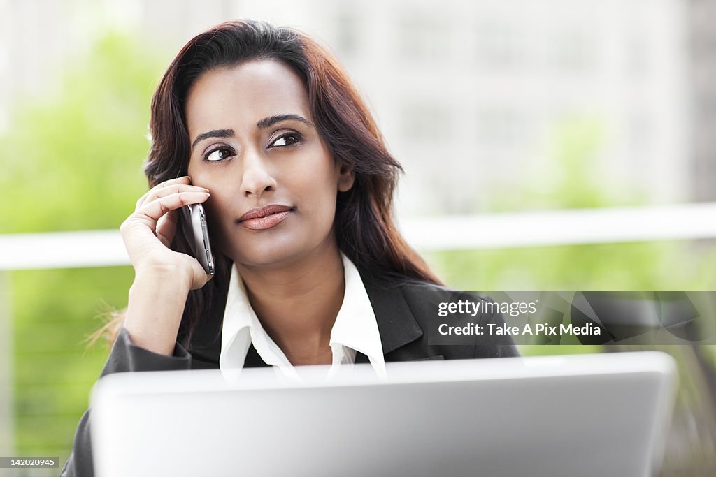 Indian businesswoman talking on cell phone