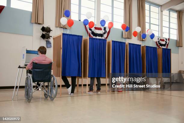 people voting in polling place - voting booth bildbanksfoton och bilder