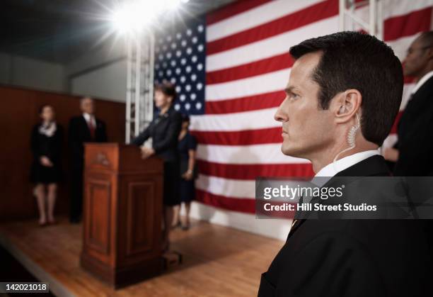 security guard with earpiece at public speech - secret service agent stock pictures, royalty-free photos & images