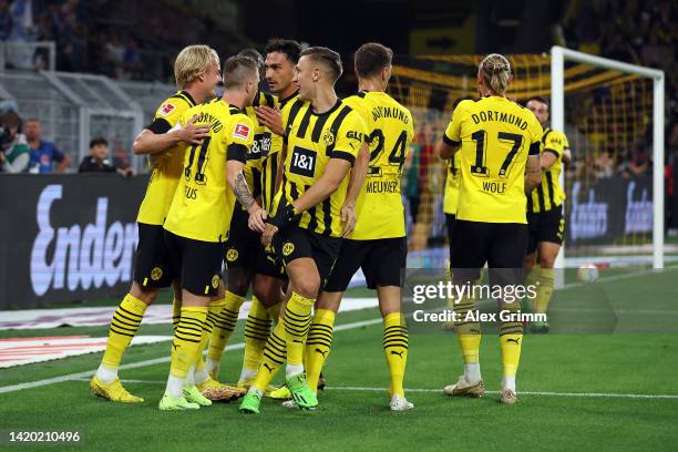 Marco Reus of Borussia Dortmund celebrates with team mates after scoring the opening goal during the Bundesliga match between Borussia Dortmund and...