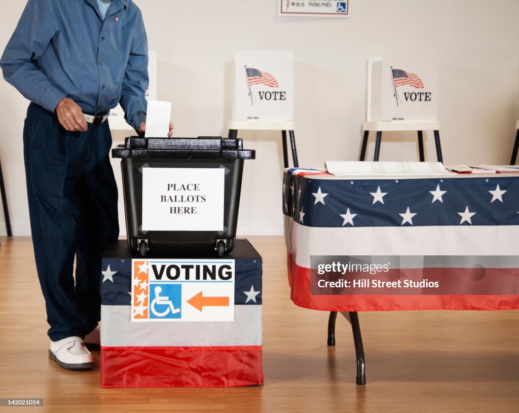 Caucasian voter voting in polling place