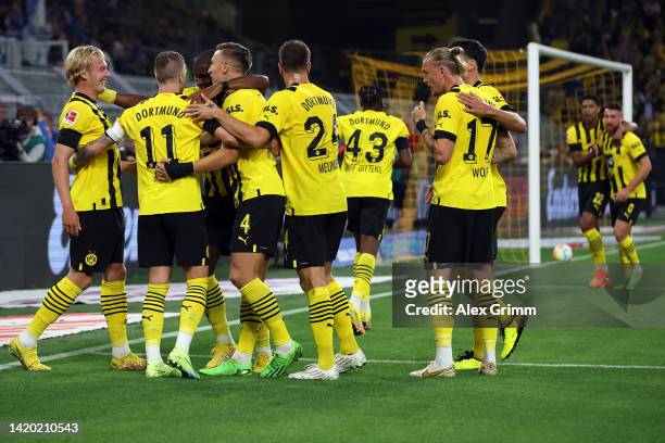 Marco Reus of Borussia Dortmund celebrates with team mates after scoring the opening goal during the Bundesliga match between Borussia Dortmund and...