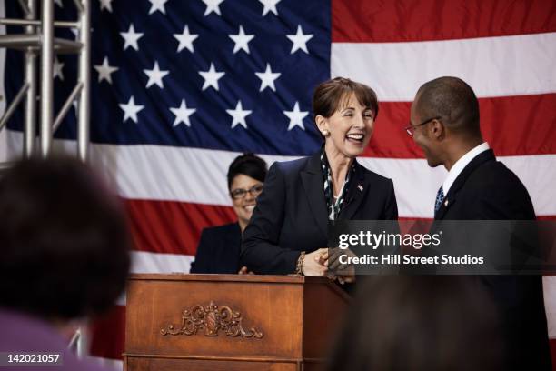 female politician making speech at podium - political talk stock-fotos und bilder