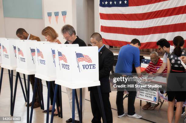 people voting in polling place - voting booth bildbanksfoton och bilder