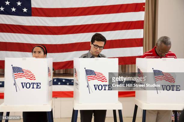 people voting in polling place - voting stock pictures, royalty-free photos & images