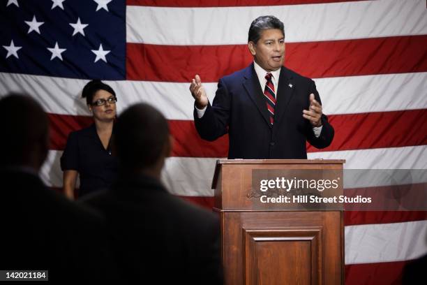 politician making speech at podium - politician stock-fotos und bilder