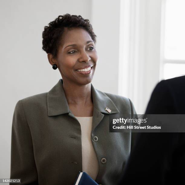 black businesswoman talking to co-worker - black politician stock pictures, royalty-free photos & images