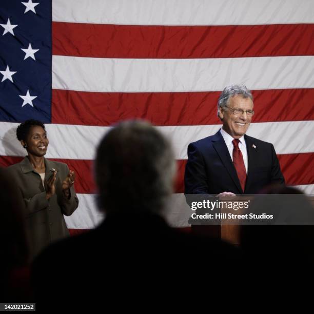 caucasian politician making speech at podium - politician back stock pictures, royalty-free photos & images