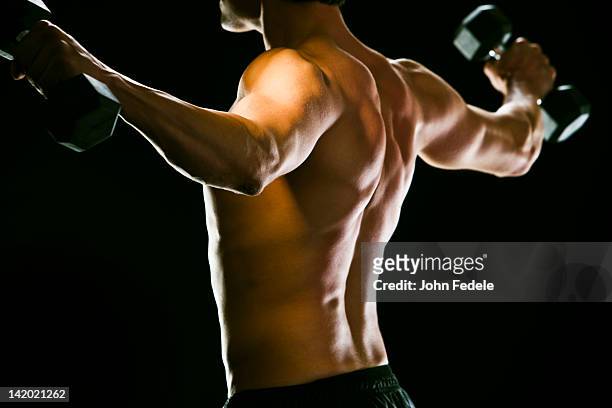 caucasian man exercising with dumbbells - ombro - fotografias e filmes do acervo