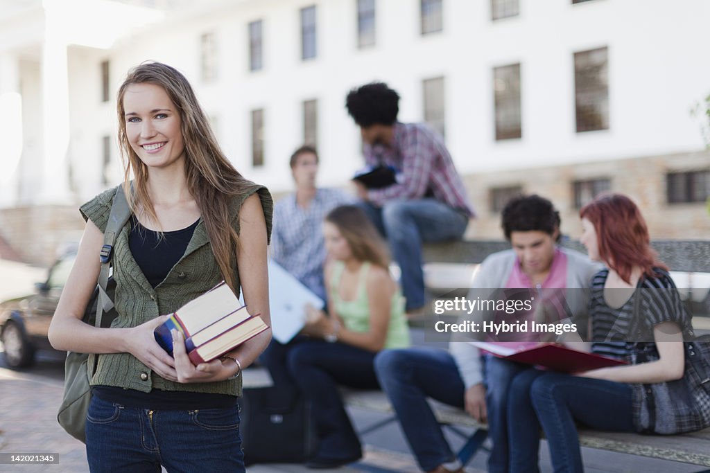 Student carrying books on campus
