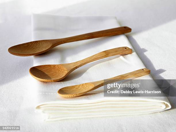 wooden spoons on folded napkin - wooden spoon stock pictures, royalty-free photos & images