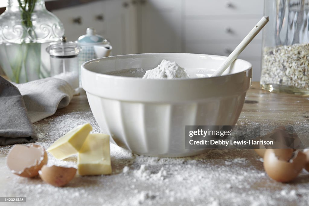 Bowl of mixing dough in messy kitchen