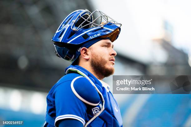 Alejandro Kirk of the Toronto Blue Jays walks the the dugout before playing against he Chicago Cubs in their MLB game at the Rogers Centre on August...
