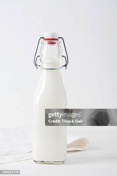 jar of milk on table - mjölkflaska bildbanksfoton och bilder