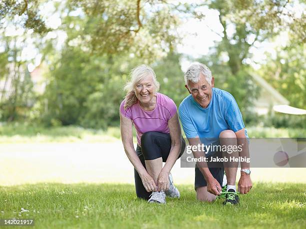 older couple tying their shoelaces - danish sports stock pictures, royalty-free photos & images