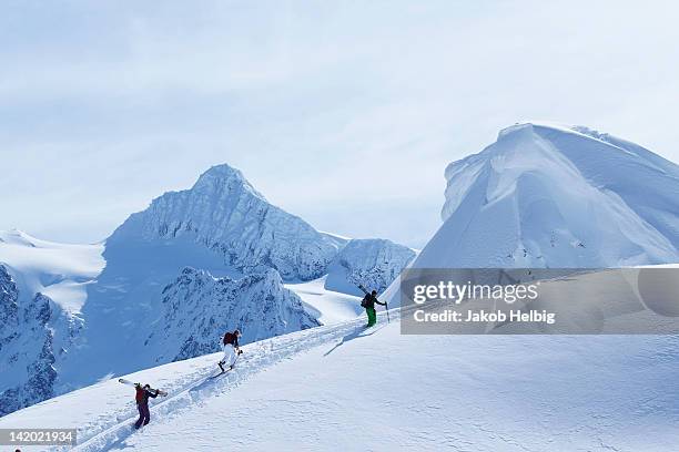 skiers climbing snowy slope - seattle winter stock pictures, royalty-free photos & images