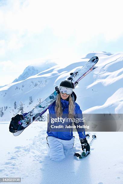 skier carrying skis in snow - seattle winter stock pictures, royalty-free photos & images