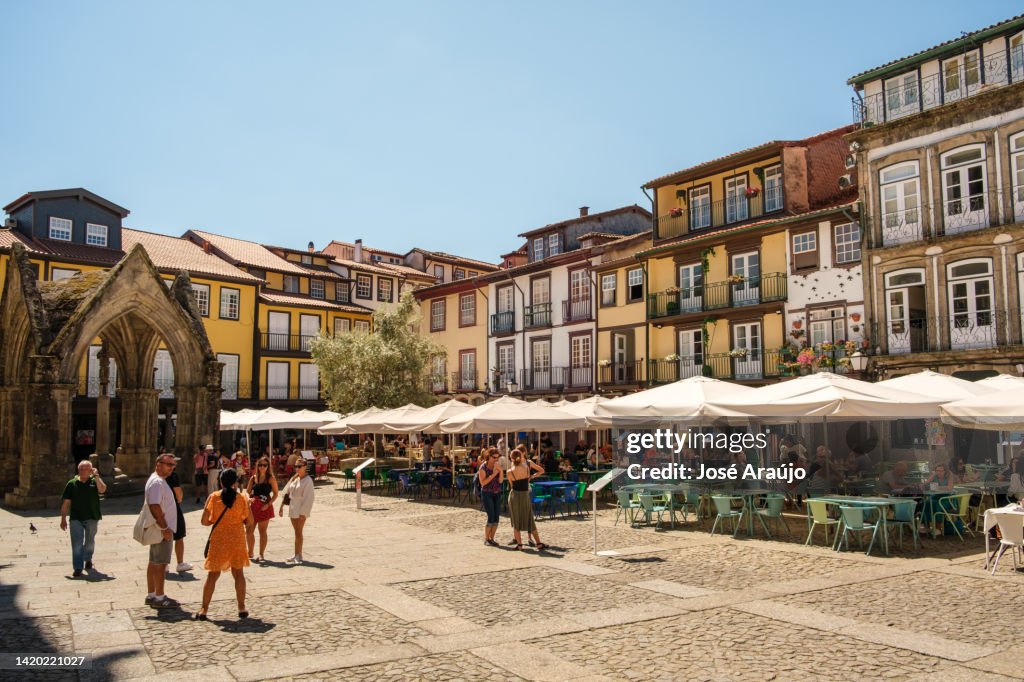 General view of the olive tree square in guimarães with several tourists