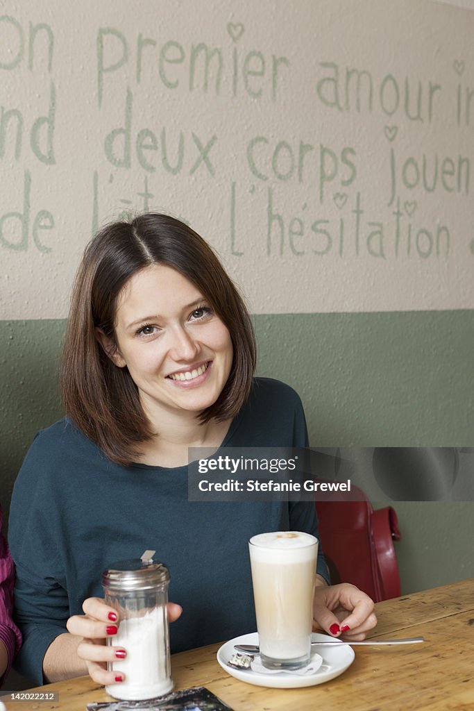 Woman having cup of coffee in cafe