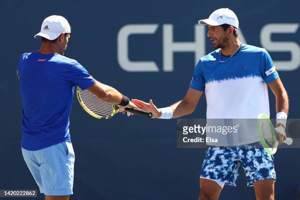 Marcelo Arevalo of El Salvador and Jean-Julien Rojer of Netherlands react to a point against Aleksandr Nedovyesov of Kazakhstan and Aisam-Ul Haq...