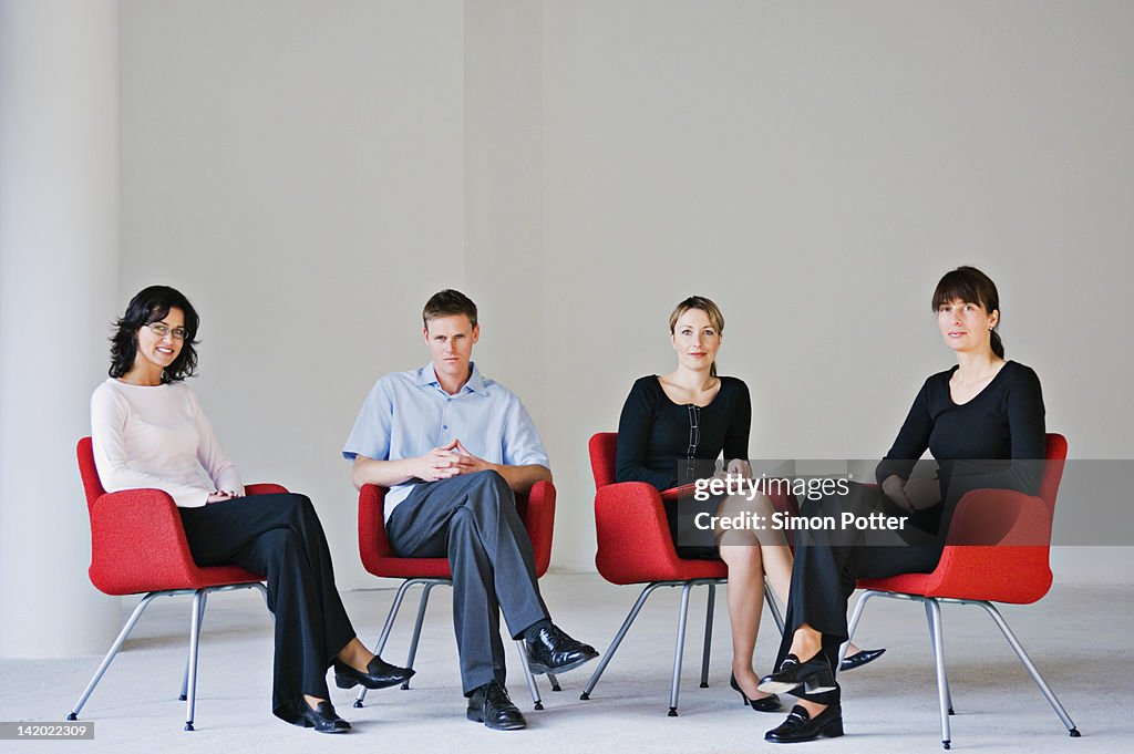 Business people sitting in office chairs