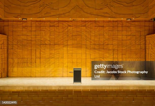 podium on stage in empty auditorium - lectern stock-fotos und bilder