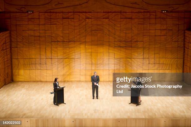 business people having debate on stage - debate stage stock pictures, royalty-free photos & images