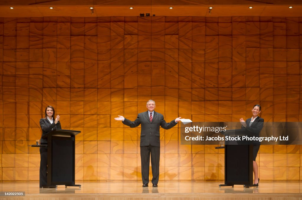 Business people having debate on stage