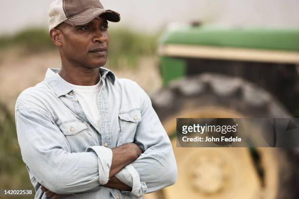 african american farmer with arms crossed - farmer arms crossed stock pictures, royalty-free photos & images