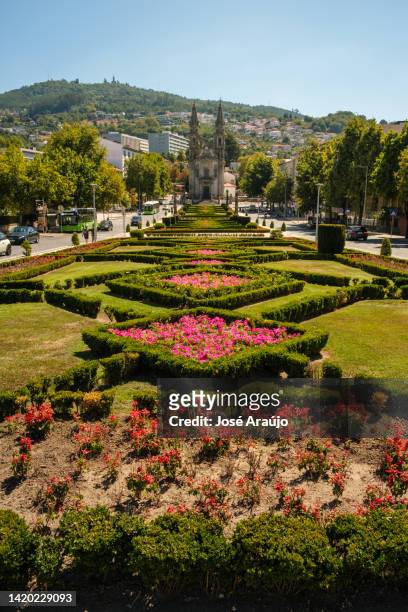 general view of the church and oratories of nossa senhora da consolação and santos passos with the garden of largo republic of brazil in front - guimarães stock pictures, royalty-free photos & images