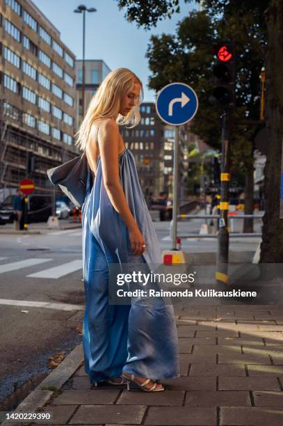 Astra is seen wearing a silk blue maxi dress and a blue bag outside Nibye x Hoss Agency during Stockholm fashion week Spring / Summer 2023 on...