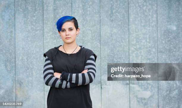 confident teenager with blue hair and arms crossed - us new wave stock pictures, royalty-free photos & images