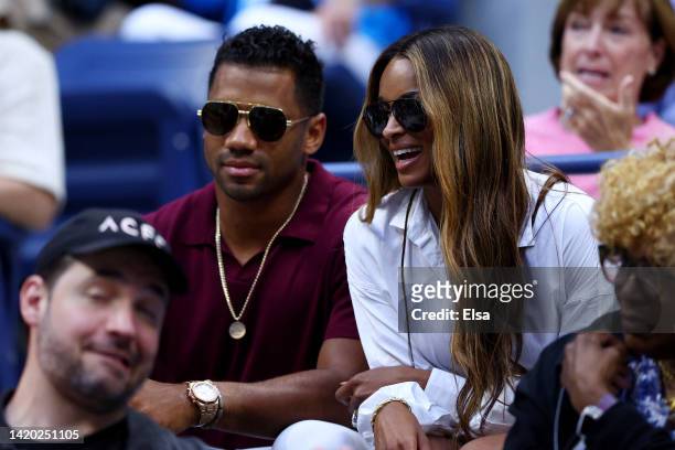 Russell Wilson of the Denver Broncos and wife Ciara look on prior to the Women's Singles Third Round match between Serena Williams of the United...