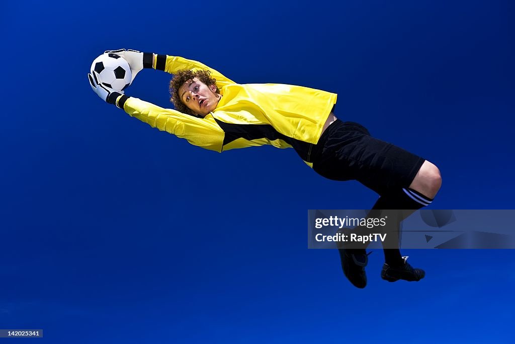 Goalkeeper stretches to make the save