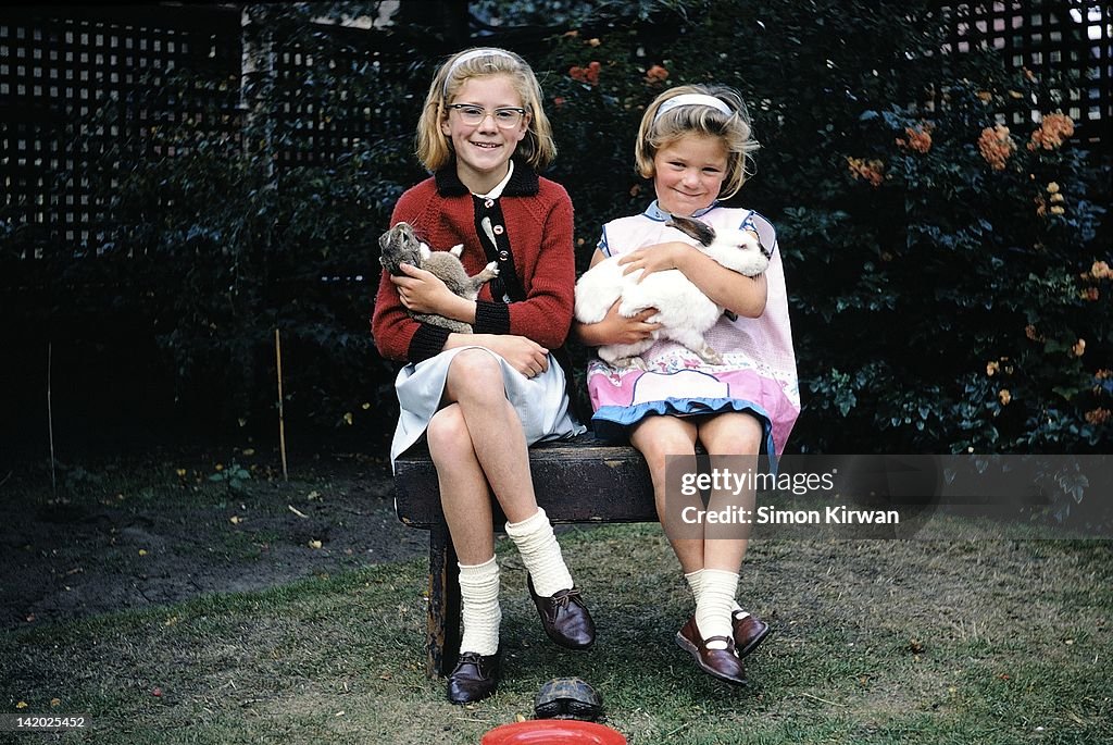 Two girls with pet rabbits