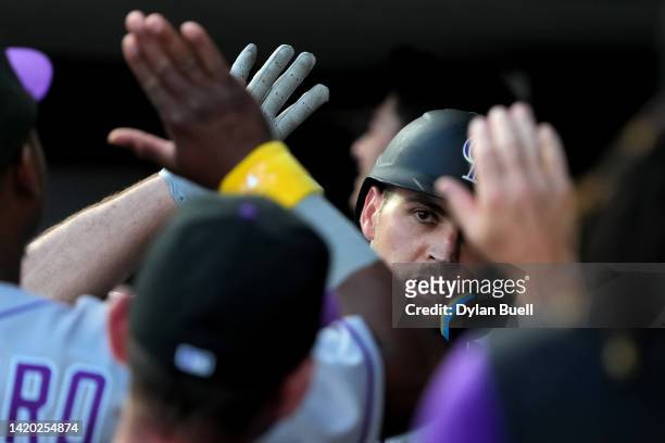 Sean Bouchard of the Colorado Rockies celebrates with teammates after hitting his first career home run in the third inning against the Cincinnati...