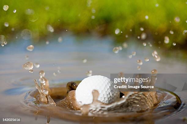 golf ball splashing into water - golf water stock pictures, royalty-free photos & images